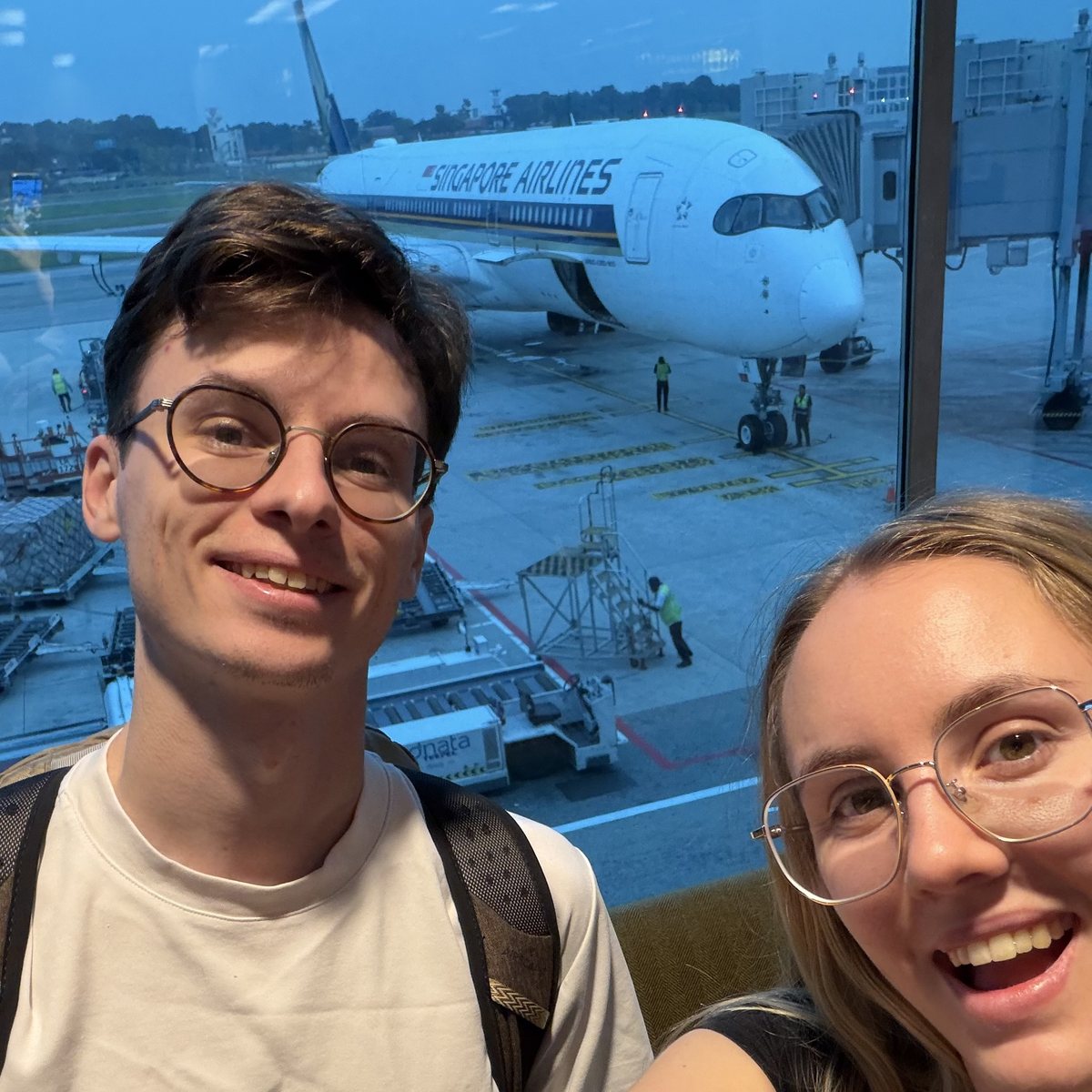 Audrey and Yoann at Changi, a Singapore Airlines A350 at the gate behind them.