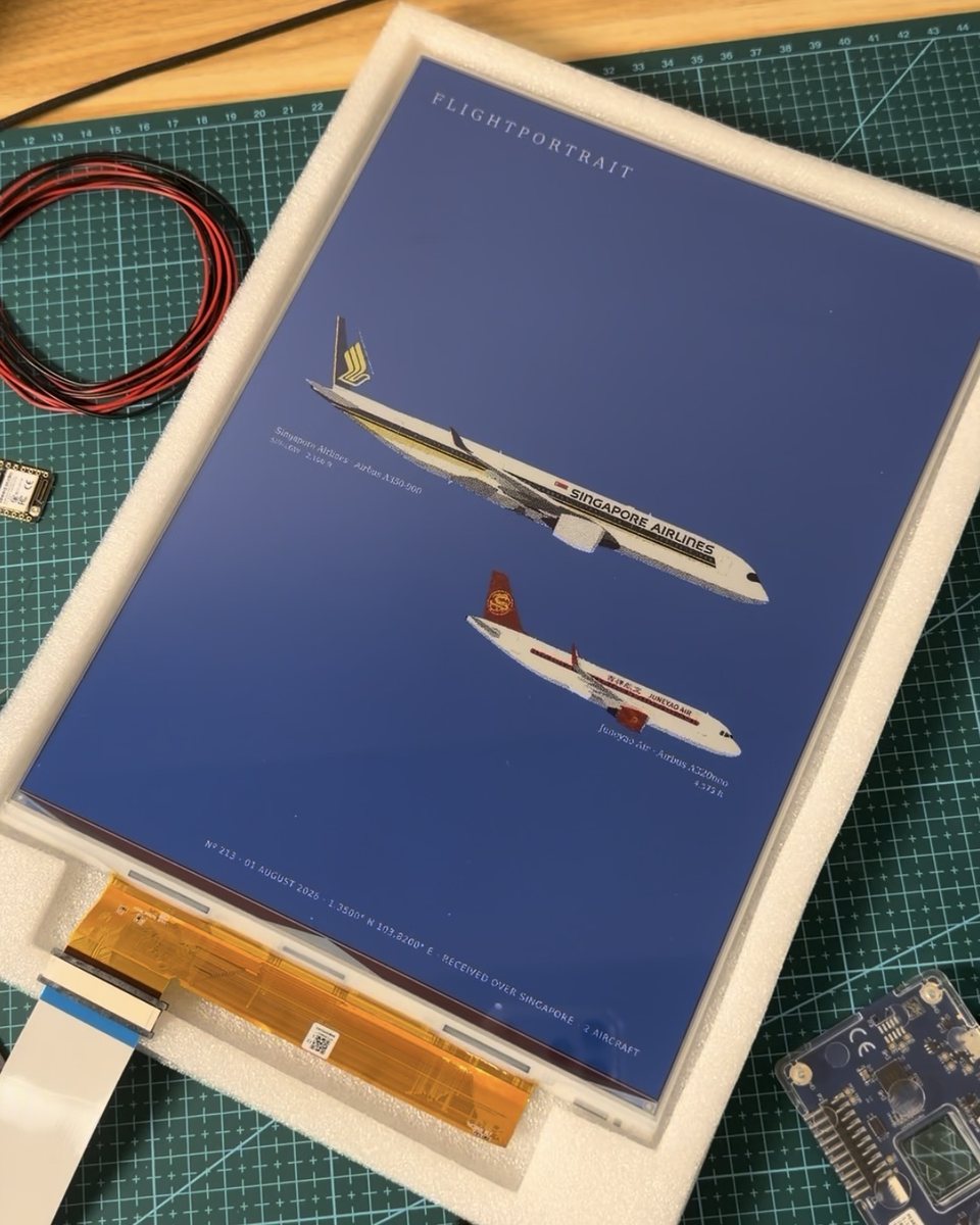 The bare e-ink panel on a cutting mat, showing a poster.
